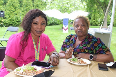 Two employees eating lunch outdoors as part of the 50 year celebration of Princeton House Behavioral Health